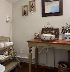 a bathroom table with a sink and a mirror at Aphrodite's Coast Retreat House! in Galaxidi
