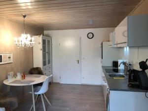 a kitchen with a table and a dining room at Bergromantik Ferienwohnung Charme mit einer Infrarotkabine und Bergblick in Marktschellenberg