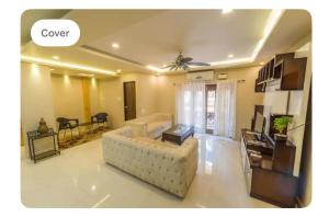 a living room with a couch and a table at Avis Home in Calangute