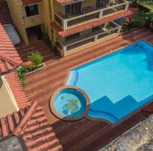 an overhead view of a swimming pool on a house at Avis Home in Calangute