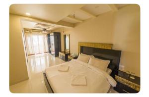 a bedroom with a large bed with two white pillows at Avis Home in Calangute +5 photos