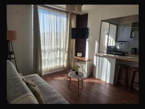 a living room with a couch and a table at Departamento COPAYAPU in El Cerrillo