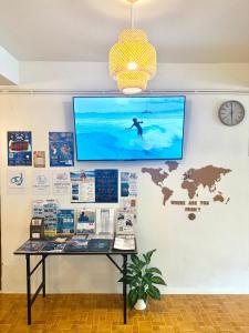 a display case with a surfer on a wall at Closca Hostel Koh Tao in Ko Tao