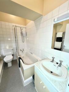 a bathroom with a sink and a tub and a toilet at Lion Royal Hotel, Rhayader in Rhayader