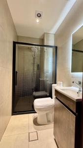 a bathroom with a shower and a toilet and a sink at Antika Amman Hotel in Amman +53 photos