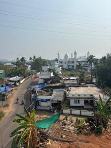 a view of a city with a street and buildings at MIRACLE Inn in Alwaye