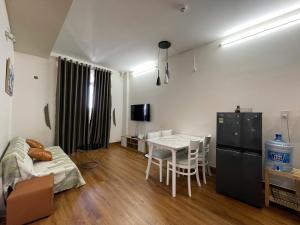 a living room with a table and a dining room at Coral Homestay Phan Rang in Kinh Dinh