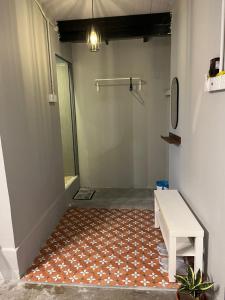 a room with a white table and a rug at Roomah En-suite attached-bath R6 in Ipoh
