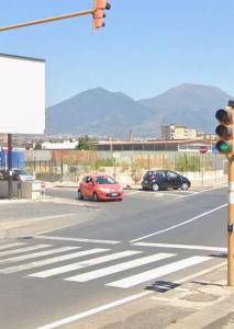 a traffic light at an intersection with cars on a street at Renova7io sweet home Napoli in Naples