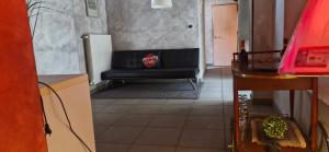 a living room with a black couch in a room at Julias house in Biella