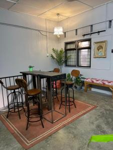 a dining room with a table and chairs at Roomah En-suite attached-bath R6 in Ipoh