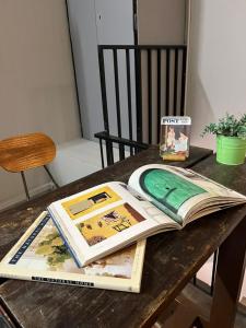 an open book sitting on a wooden table at Roomah En-suite attached-bath R6 in Ipoh +21 photos