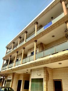 a tall building with columns on top of it at Green Appart 1 chambre et salon in Cotonou