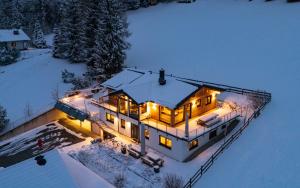 an aerial view of a house in the snow at Austrian Alpine Apartments in Ramsau am Dachstein