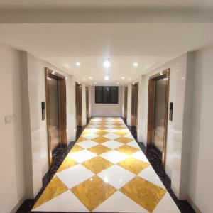 an empty hallway with a checkered floor in a building at Sky House BSD Apartment by Casanova in Cilenggang +11 photos