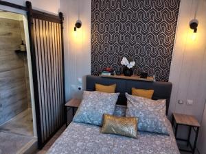 a bedroom with a bed with pillows and a wall at chambre Marseille pas lon de saint Charles et vieux port in Marseille