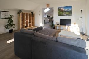 a living room with a couch and a table at Gemeinschaftswohnung mit privaten Zimmern in Diepholz +16 photos