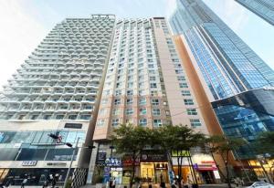 a tall building in a city with a street at Haeundae Beach Stay Hotel in Busan