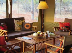 a living room with a couch and a table at Iphofolo Lodge & Tented Camp in Vivo