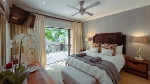 a bedroom with a bed and a large window at Upper Classic in Clarens