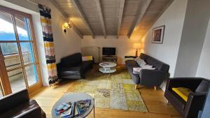 a living room with two couches and a tv at Jungholz Erlebnis in Jungholz