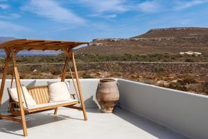 a porch with a gazebo and a chair at Ammos Boutique Villa in Elafonisos