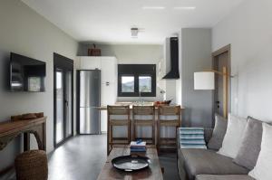 a living room with a couch and a table at Ammos Boutique Villa in Elafonisos
