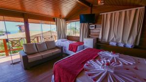 a room with a bed and a couch in a room at Anexo à Pousada WindJeri in Jericoacoara