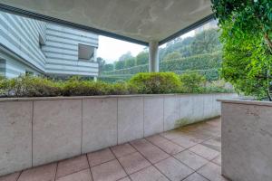 an outdoor patio with plants and a building at Sergio's house in Como