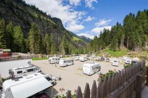 a group of rvs parked in a parking lot at Camping Bergkristall in Moso
