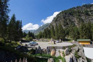 a car parked in a parking lot in front of a mountain at Camping Bergkristall in Moso