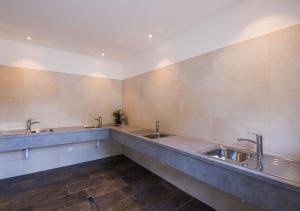 a bathroom with three sinks and two faucets at Camping Bergkristall in Moso +27 photos