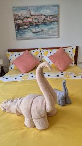two stuffed animals are sitting on a bed at PB329 Phuket's best oceanfront studio in Ban Mai Salae +14 photos