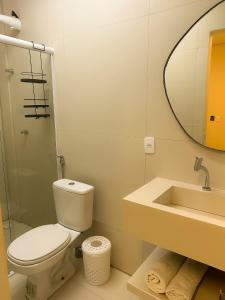 ein Badezimmer mit Toilette, Waschbecken und Spiegel in der Unterkunft TERESINA HOTEL in Teresina