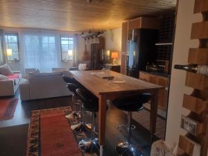 a kitchen with a large wooden table and bar stools at Haby House in Skene +95 photos