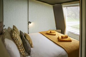 a bedroom with a large bed with towels on it at King Fisher in Nantmel