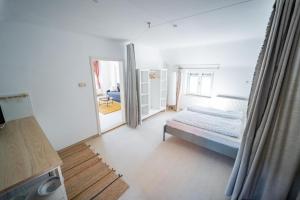 a bedroom with a bed and a mirror at Wohnen bei Schörgi in Grein