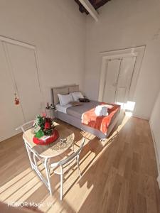 a bedroom with a bed and a table and chairs at La Dimora di Tuya Superior in Naples