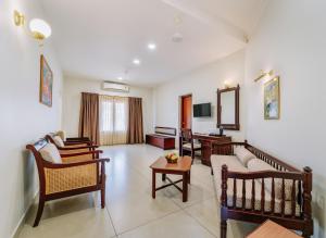 a living room with chairs and a table at Silver Crest Resort in Thekkady