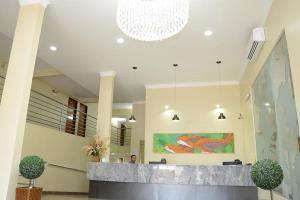 a lobby with a reception desk in a building at Requinte Hotel in Altamira