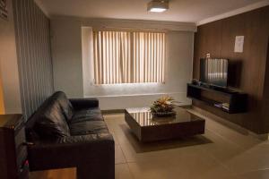 a living room with a couch and a coffee table at Requinte Hotel in Altamira