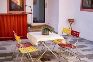 a table and four chairs and a table and a table at Wohnen bei Schörgi in Grein