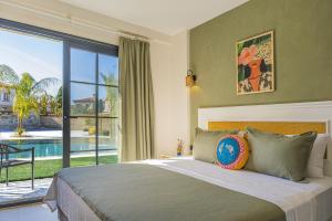 a bedroom with a bed with a view of a pool at Lyse Jülide Hotel in Çeşme