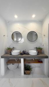 a bathroom with two sinks and two mirrors at LA Casa Di Lusso N7 -Adults Only in Kolymbia