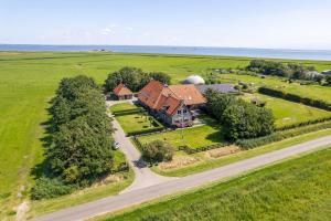 an aerial view of a house with a farm at Ballumerhoeve Skip lodge in Ballum