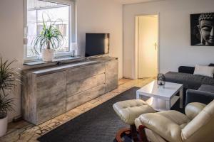a living room with a couch and a tv at Apartment 1 in Diepholz