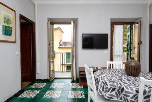 a dining room with a table and a view of a balcony at Casa Di Mezzo by Arbaspàa in Manarola