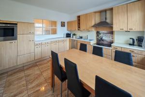 a large kitchen with a wooden table and chairs at Apartment 1 in Diepholz