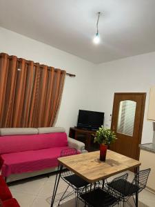 a living room with a couch and a table at Andi's GuestHouse in Sarandë