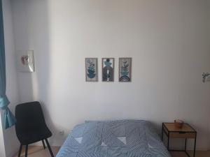 a bedroom with three pictures on the wall at Le Cocoon Léréen in Léré